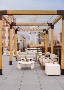 a rooftop patio with couches and tables on a building at Sonder Ovation in Philadelphia