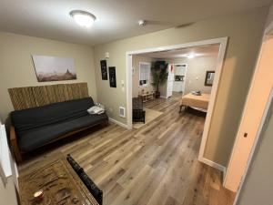 a living room with a bed and a hallway at Far East Escape- Salem in Salem