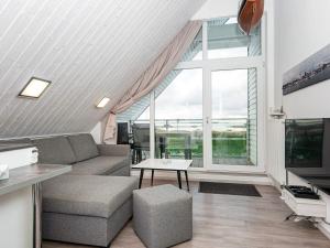 a living room with a couch and a tv at 4 person holiday home in Wendtorf in Wendtorf