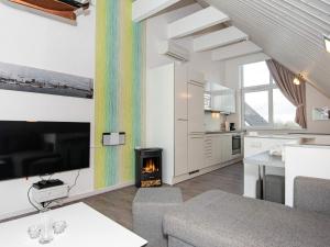 a kitchen and living room with a fireplace in a house at 4 person holiday home in Wendtorf in Wendtorf