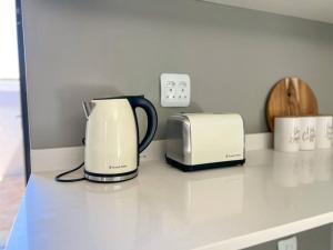 a coffee maker and toaster sitting on a kitchen counter at Langebaan Holiday Home in Langebaan