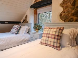 a bedroom with two beds and a window at Oakhurst in Newton Abbot