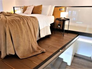 a bedroom with a bed with a blanket on the floor at Loft Orvieto Centro Storico, Wi-Fi e Netflix vicino Pozzo della Cava,"Carvajal Rooms" in Orvieto