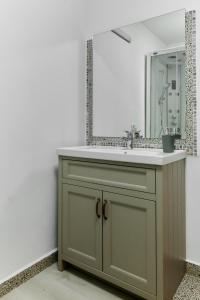 a bathroom with a sink and a mirror at Pensiune Arada in Arad