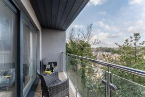 a balcony with two chairs and a view of the city at Azure in Bournemouth