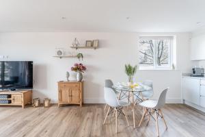 a kitchen and dining room with a table and chairs at Azure in Bournemouth