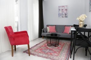 a living room with a couch and a red chair at Ditto Flats in Istanbul