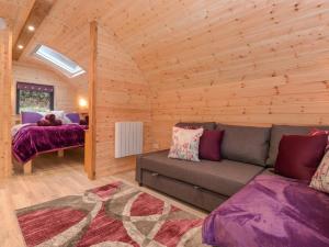 a living room with a couch in a log cabin at Lovies Place - Crossgate Luxury Glamping in Penrith
