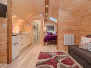 a kitchen and living room in a log cabin at Lovies Place - Crossgate Luxury Glamping in Penrith