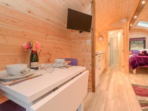a kitchen with a white counter top in a wooden cabin at Lovies Place - Crossgate Luxury Glamping in Penrith
