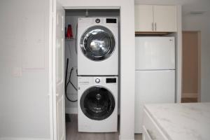 a washer and dryer in a white kitchen at Patio I Firepit I 65 TV w/ Netflix I 472mbps I WD in Vero Beach