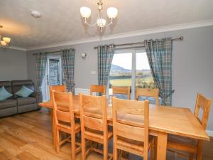 a dining room with a wooden table and chairs at Pen Y Banc in Builth Wells