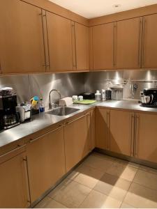 a kitchen with wooden cabinets and a sink at Fairytale in Sony Center Berlin in Berlin