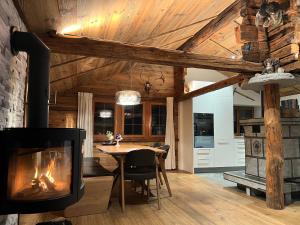 a living room with a fireplace and a dining table at Châlet Birkhahn in Saas-Fee