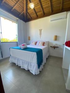 a bedroom with a large bed with a large window at Villa Ohana - Taipu de Fora in Taipu +23 photos