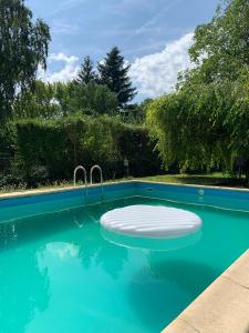 a swimming pool with a mattress in the water at Zsuzsa Apartmanház in Sukoró