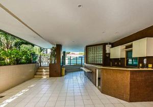 a large kitchen with a view of the water at Flat - Leblon in Rio de Janeiro