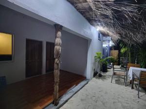 a living room with a pole in the middle of a room at Rashuthere Maldives in Rasdhoo