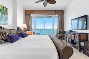 a bedroom with a large bed and a television at La Playa 801 in Perdido Key