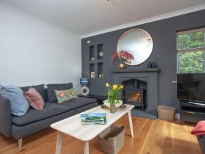 a living room with a blue couch and a mirror at Harbour Heights in Brixham