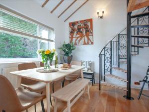 a dining room with a table and chairs and a staircase at Harbour Heights in Brixham