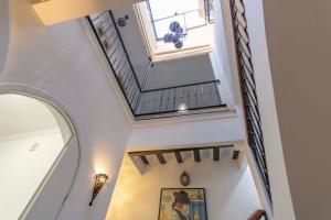 a staircase in a home with a vaulted ceiling at House -Rooftop&Jacuzzi -StayInSeville in Seville