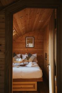 a bedroom with a bed in a wooden room at Daffodil in Rhayader