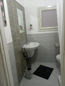 a bathroom with a sink and a toilet at Appartamento Lorena in Trapani