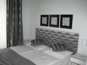 a bed with two pillows on it in a bedroom at Pension Schottentor in Vienna