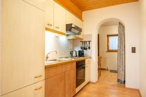 a kitchen with a sink and a stove at Marlis Apartments in Ischgl