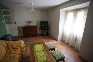 a living room with a couch and a tv at Holiday Home Mihovilovic in Premantura
