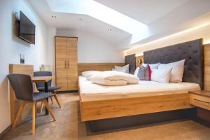 a bedroom with a large bed and a desk at Marlis Apartments in Ischgl