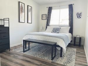 a bedroom with a bed with a window and a rug at Lovely Apartment Unit Near Central Coalinga in Coalinga