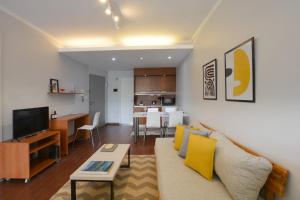 a living room with a couch and a dining room at Minimalist design apartment with amazing view in Buenos Aires