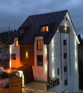 une maison est en construction avec ses lumières allumées dans l'établissement Apartman GLECER KOP, à Kopaonik