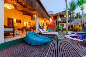 an outdoor patio with bean bags on the deck of a house at Pousada La Vie Jeri in Jericoacoara