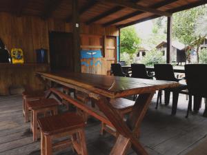 a large wooden table in a room with chairs at Mamá Orbe Family Eco Farm in El Valle