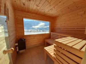 a sauna with a bench and a window at Ferienwohnung Sunnseitn in Haus im Ennstal