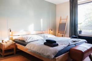 een slaapkamer met een bed, een stoel en een raam bij Zentrale & gemütliche 3-Zimmer-Wohnung, mit Netflix & Sky, in der Nähe von Uni, Klinikum & Zentrum, mit Stellplatz in Kassel