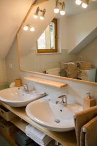 a bathroom with two sinks and a large mirror at House Pucnk-beautiful countryside in Železniki