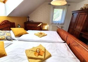 a bedroom with two beds with towels on them at House Pucnk-beautiful countryside in Železniki