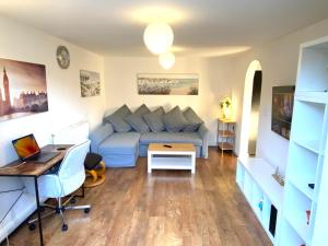 a living room with a couch and a table at Modern & Stylish 2 Bedroom Apartment! - Ground Floor - FREE Parking for 2 Cars - Netflix - Disney Plus - Sky Sports - Gigabit Internet - Newly decorated - Sleeps up to 5! - Close to Bournemouth Train Station in Bournemouth