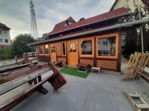 a wooden cabin with a bench in front of it at kuća za odmor marković in Kopaonik