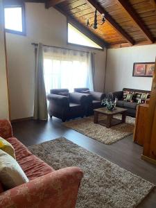 uma sala de estar com um sofá e uma mesa em Acogedora casa céntrica en Panguipulli em Panguipulli