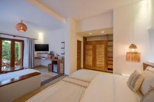 A bed or beds in a room at Ana y Jose Hotel & Spa Tulum