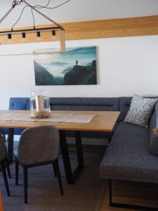 a dining room with a table and a couch at Chalet 1480 in Gaschurn
