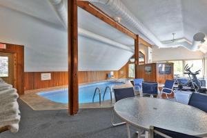 a large swimming pool with a table and chairs at Fall Line Condos by Killington VR - 2 Bedrooms in Killington