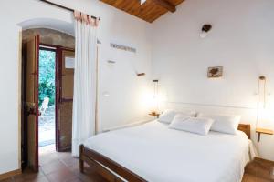 um quarto com uma cama branca e uma janela em Agriturismo Terra Di Pace em Noto