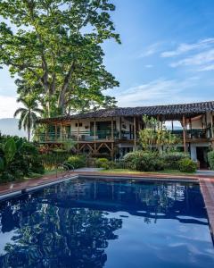 a resort with a swimming pool in front of a building at Hacienda Bambusa in El Caimo