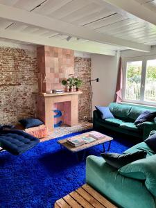 a living room with a couch and a table at Little Secret Zeeland + ligbad in Schoondijke